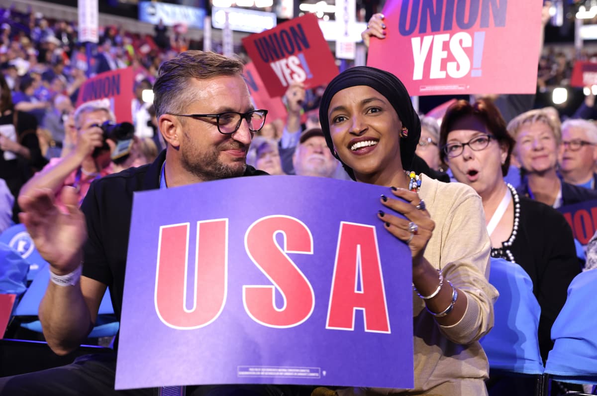 Congresswoman Ilhan Omar sits with husband Tim Mynett during the first day of the Democratic National Convention at the United Center on August 19, 2024 in Chicago, Illinois.  