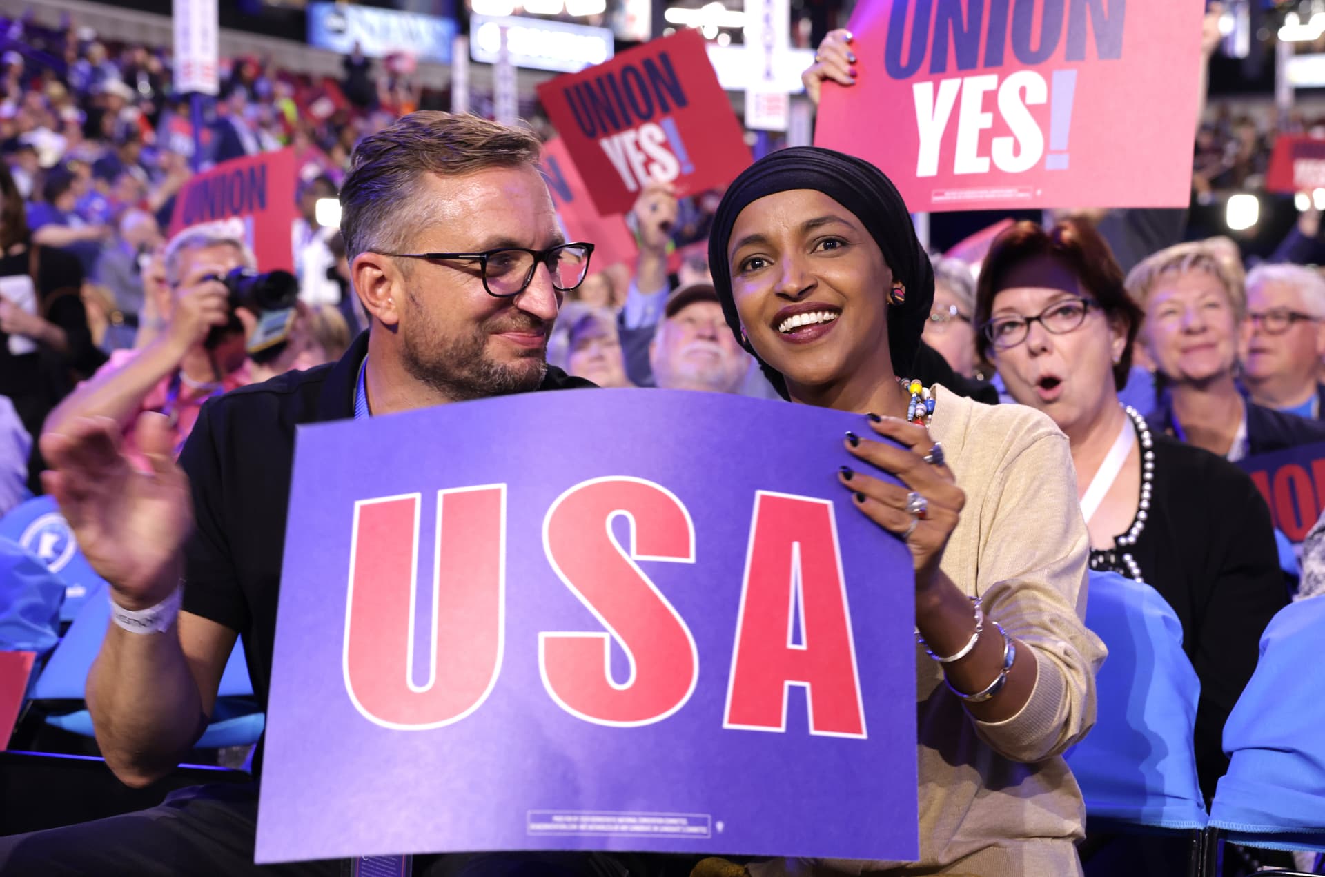 Congresswoman Ilhan Omar sits with husband Tim Mynett during the first day of the Democratic National Convention at the United Center on August 19, 2024 in Chicago, Illinois.  