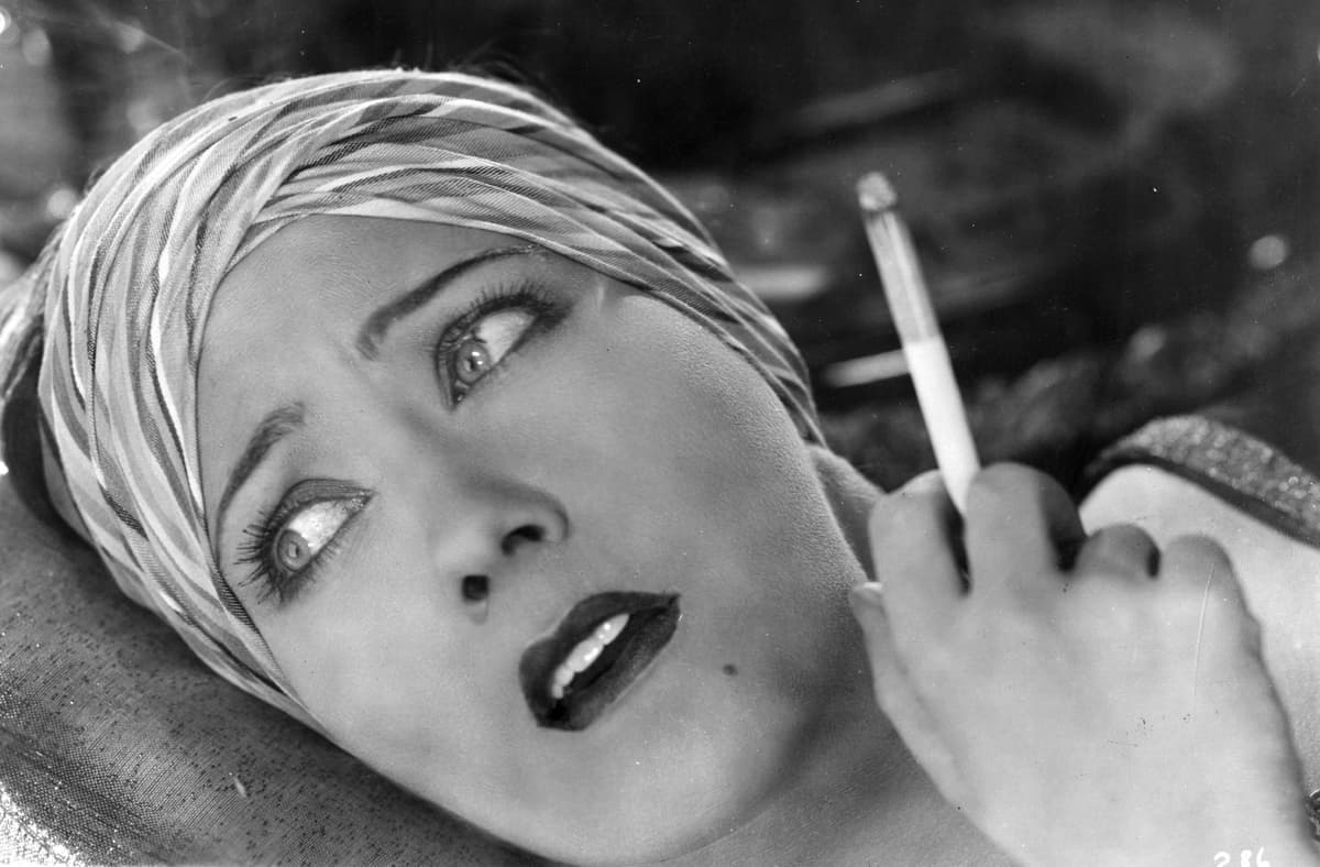 Gloria Swanson, cigarette in hand. 