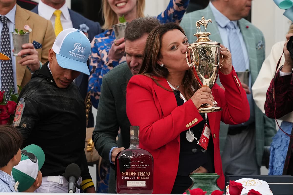 Trainer Cherie DeVaux kisses the trophy after a victory by Golden Tempo in the 152nd running of the Kentucky Derby horse race at Churchill Downs, May 2, 2026, at Louisville, Ky.