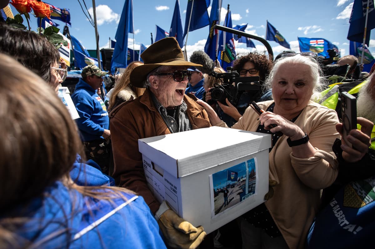 Supporters carry boxes of signatures to submit for an Alberta separation referendum at Edmonton on May 4, 2026.