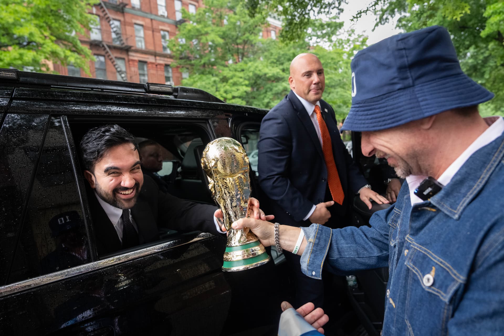 New York Mayor Zohran Mamdani is passed a replica World Cup Trophy. 