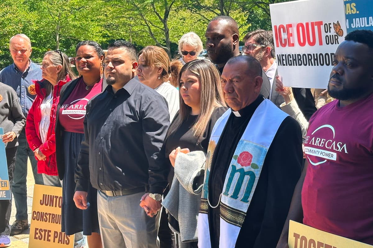 Kilmar Abrego Garcia and his wife hold hands as people rally in support of him outside federal court after a hearing in his case at Greenbelt, Maryland, on May 12, 2026.