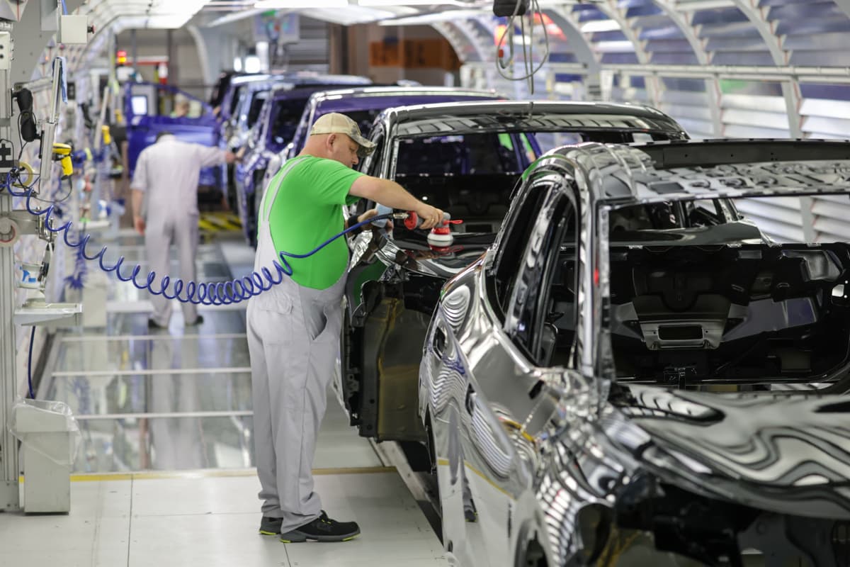An assembly worker performs final checks on electric cars at a Volkswagen factory at Emden, Germany, on February 24, 2026. 