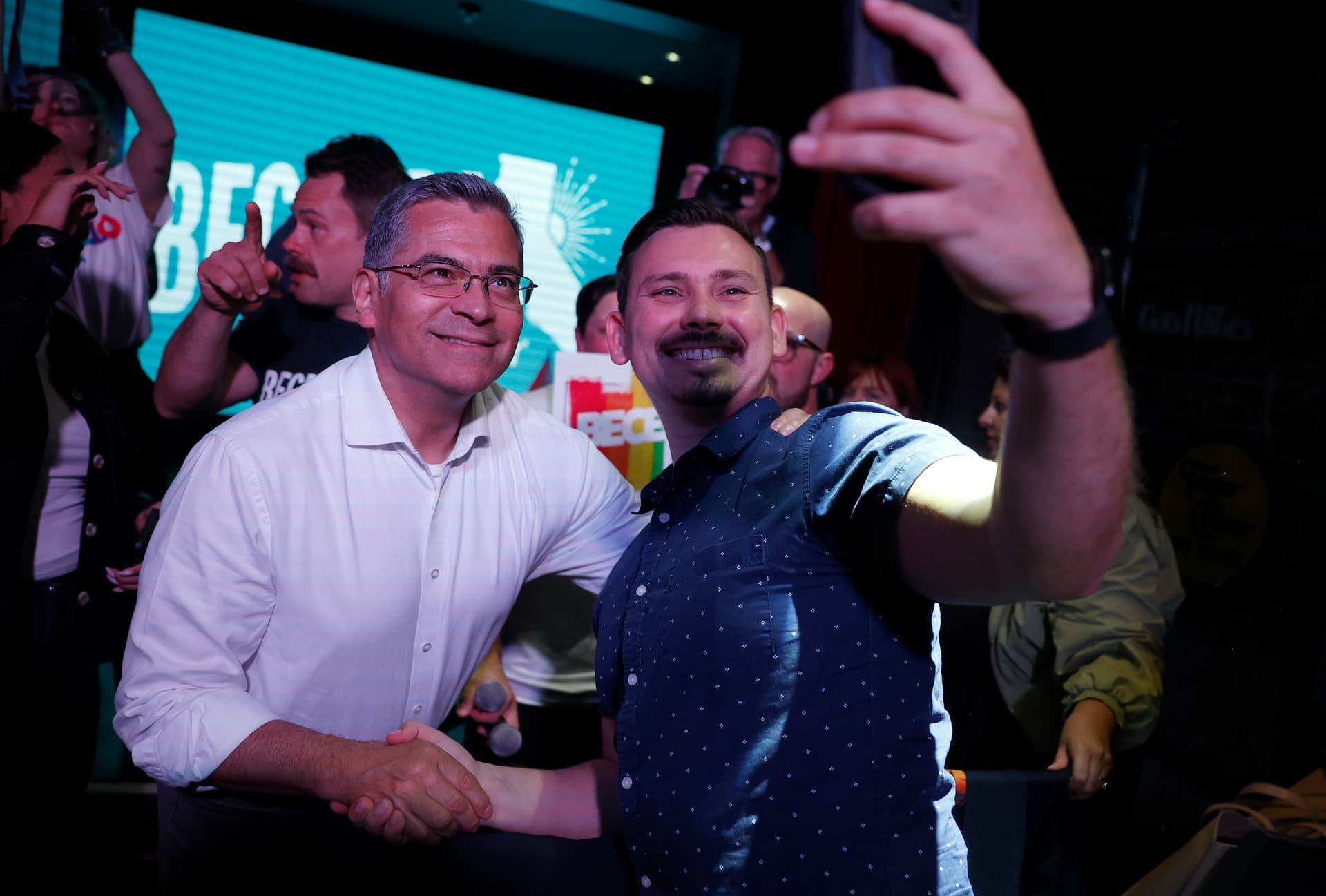 California’s front-running  gubernatorial candidate, Xavier Becerra, poses for a selfie with a supporter at West Hollywood on May 28, 2026.
