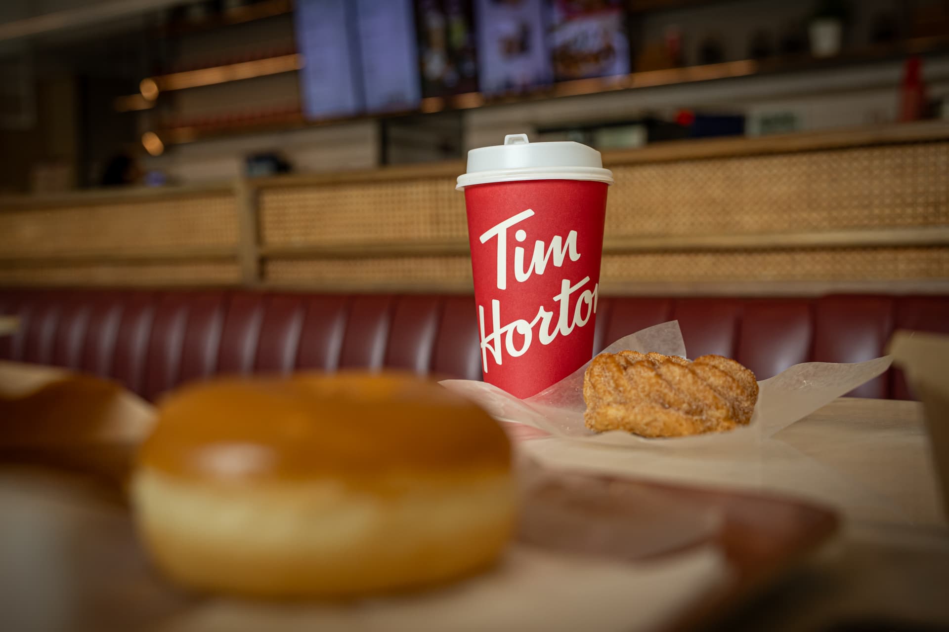 A Tim Hortons coffee and doughnut on display.