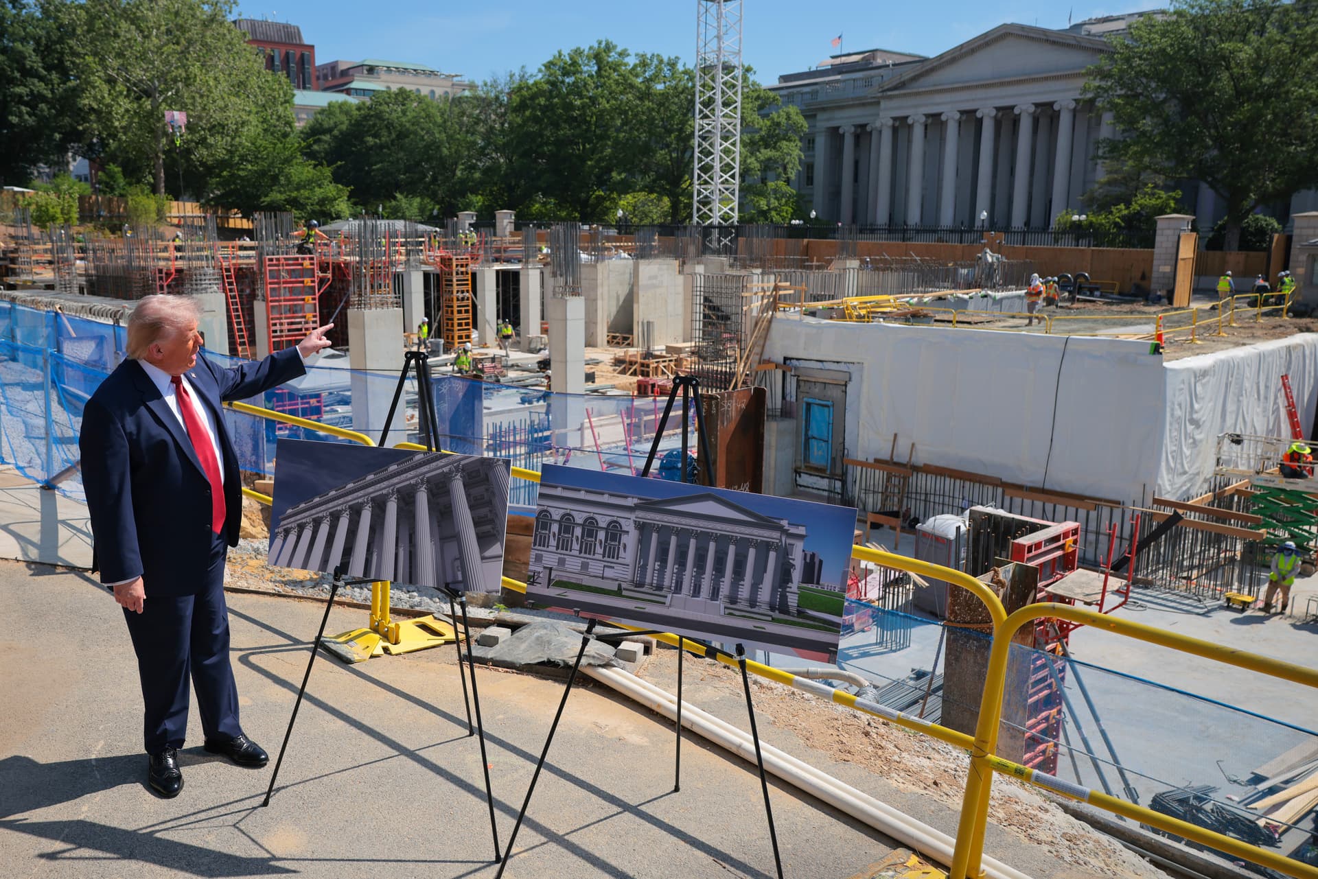 President Trump speaks to the media alongside posters of his proposed White House ballroom amid construction at the White House on May 19, 2026, at Washington, D.C.