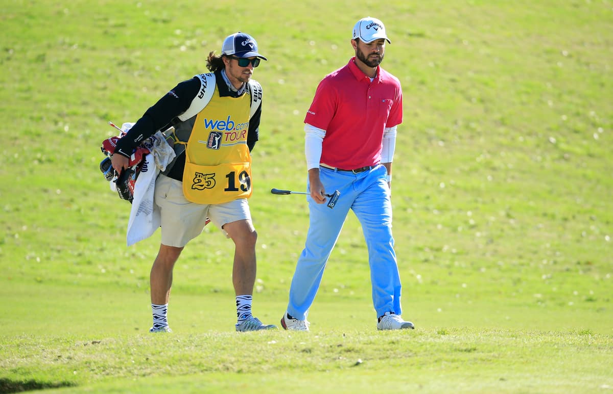 FILE: Wesley Bryan (red shirt) and his brother and caddie George Bryan IV walk the fairway during the final round of the Chitimacha Louisiana Open held at Le Triomphe Golf and Country Club at Broussard, Louisiana, on March 20, 2016. 