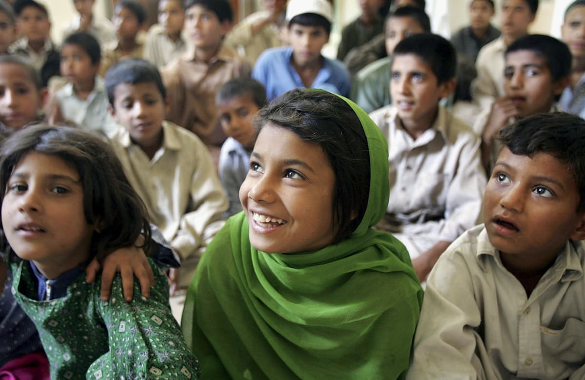 FILE: Street children listen during an AIDS awareness class on April 21, 2006, at a daytime shelter at Peshawar, Pakistan. 