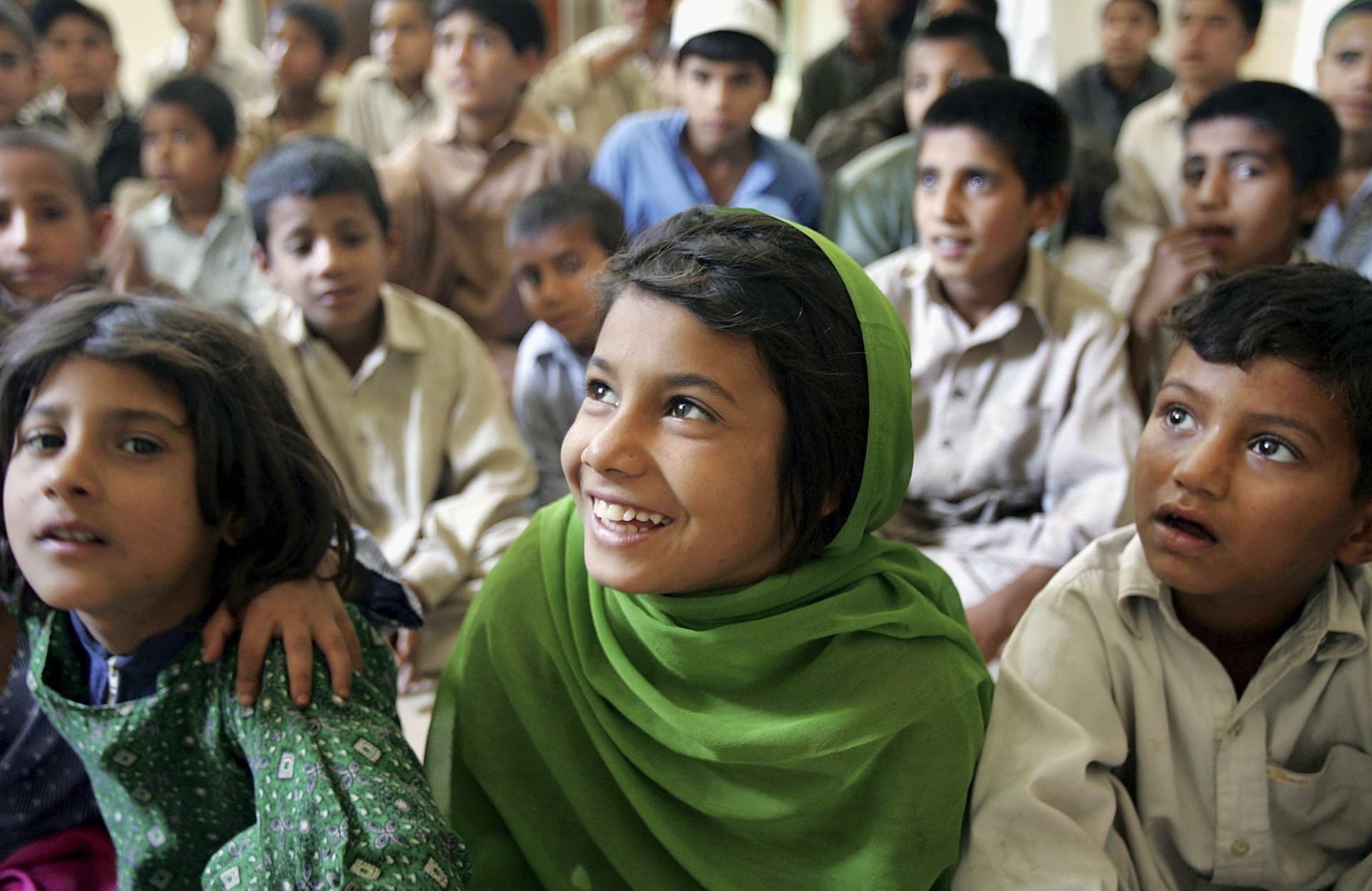 FILE: Street children listen during an AIDS awareness class on April 21, 2006, at a daytime shelter at Peshawar, Pakistan. 
