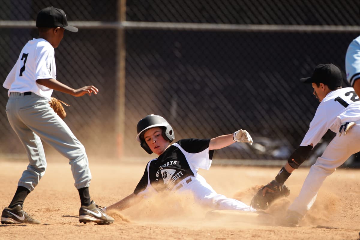 A young baseball player slides into second base during a Little League competition at Norwalk, Connecticut.