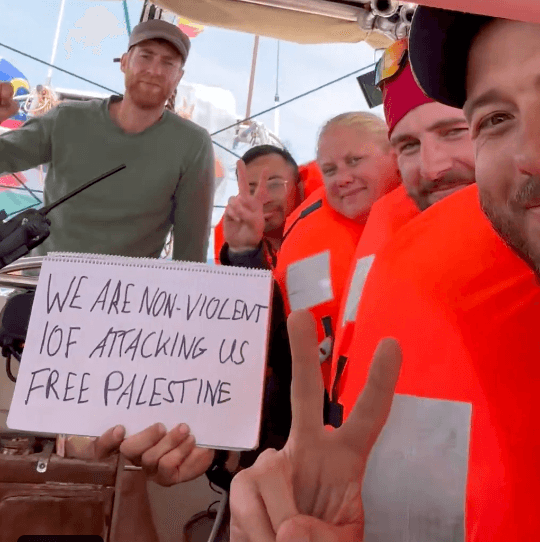 Passengers say Israeli forces are 'attacking a humanitarian flotilla' and jamming emergency channels.