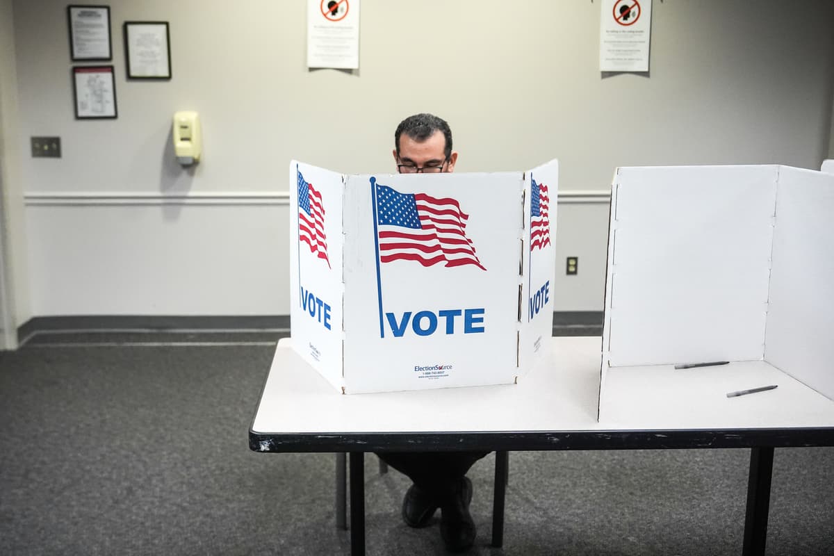 A voter fills out his ballot in the Virginia redistricting referendum at Fairfax, Virginia, on April 21, 2026.