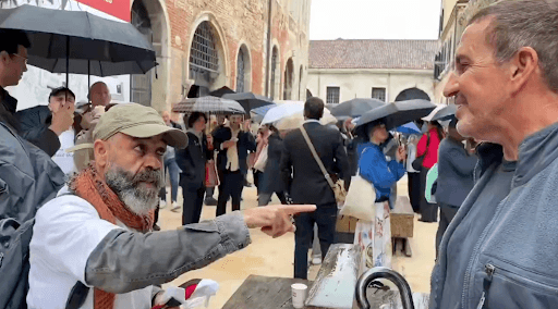 Peace activist Eyal Waldman is seen being approached at a protest of Israel's inclusion in Venice’s biennial art and culture exhibition.