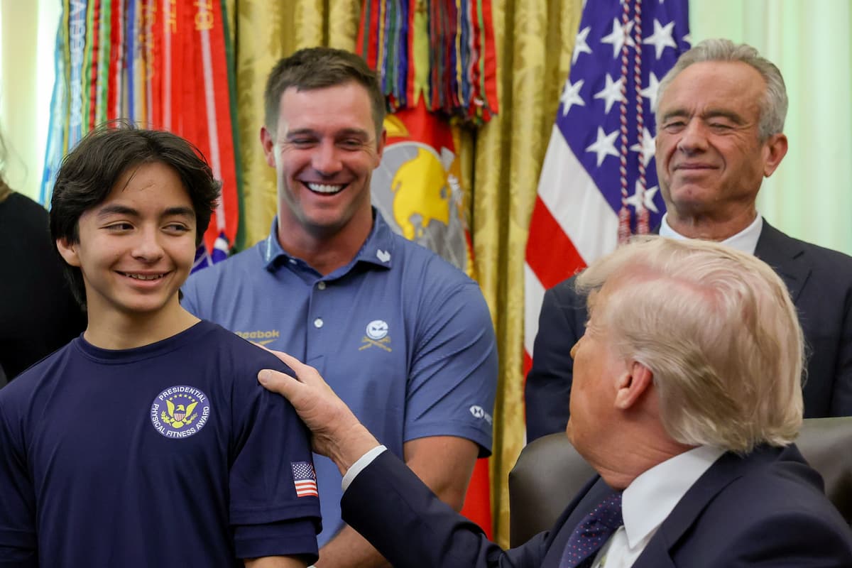 President Trump speaks to young athletes as he is joined by (L-R) professional golfer Bryson DeChambeau and Secretary of Health and Human Services Robert F. Kennedy Jr. during a proclamation signing in the Oval Office of the White House on May 5, 2026 in Washington, D.C. 