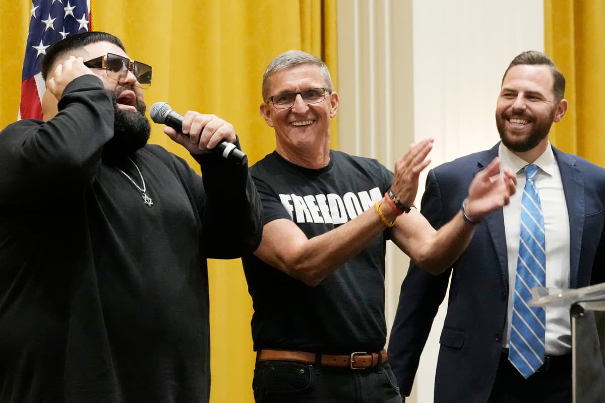Gen. Michael Flynn (retired), center and Pastor Jackson Lahmeyer listen to Jimmy Levi sing during the ReAwaken America Tour, Pastors for Trump event, October 12, 2023, in Doral, Florida. 