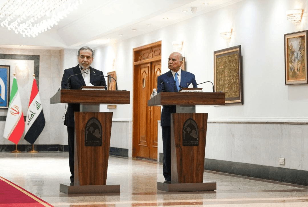 Foreign ministers Abbas Araghchi of Iran and Fuad Hussein of Iraq speak to reporters at a press conference at Baghdad on June 28, 2026.
