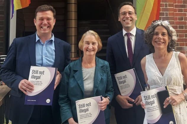 Backers of a British bill to ban conversion therapy display a report on the issue that they presented to members of Parliament at London on June 25, 2026.