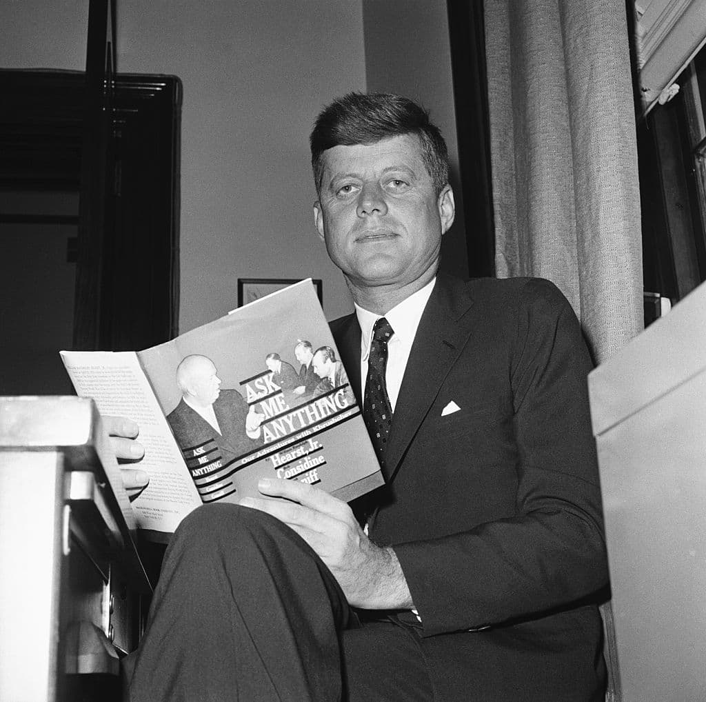 John F. Kennedy reading 'Ask Me Anything,' by William Randolph Hearst Jr., and others, in June 1960.