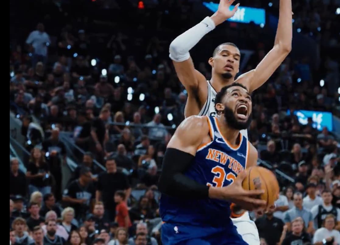 Number 32 Karl‑Anthony Towns scores for the New York Knicks during the finals against the San Antonio Spurs.