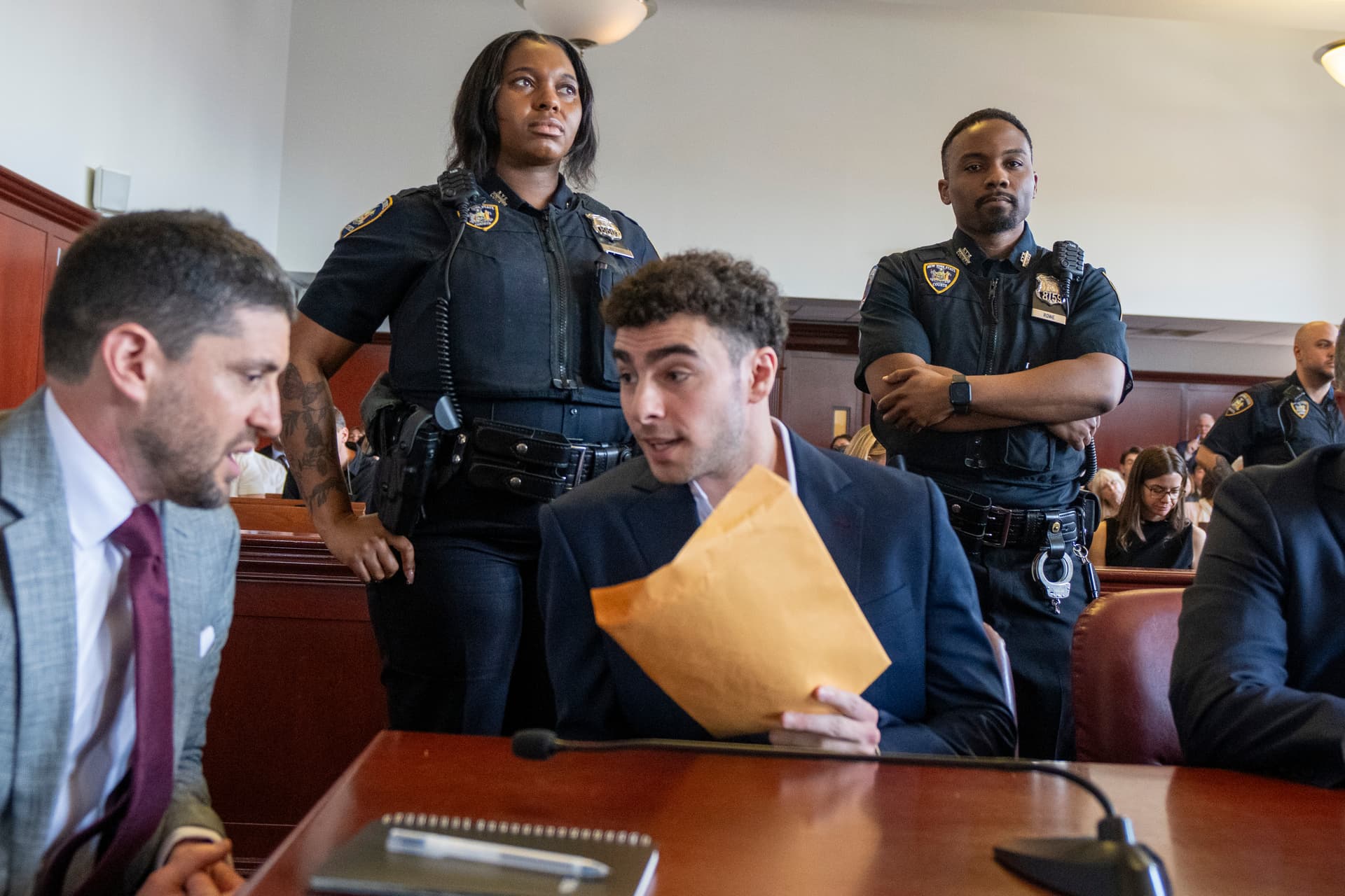 Murder suspect Luigi Mangione speaks with his attorney Jacob Kaplan during an appearance in Manhattan Supreme Court at New York City on June 17, 2026.