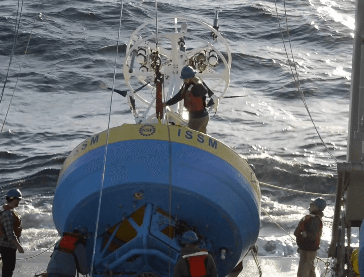 A team member with the Ocean Observatories Initiative readies a buoy for deployment.