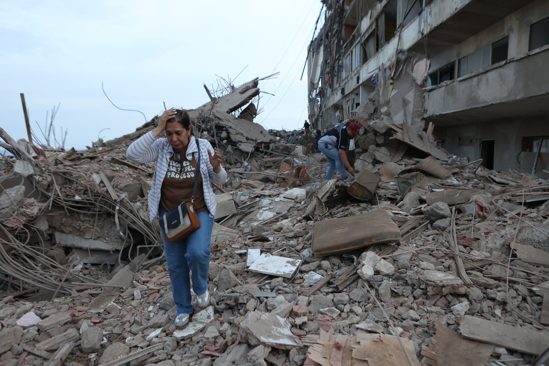 A woman walks through the rubble of buildings damaged by this week’s twin earthquakes at Catia La Mar, Venezuela, on June 25, 2026.