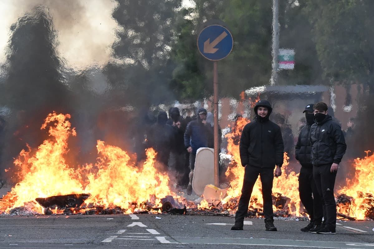 Charles McQuillan/Getty Images Youths gather in front of a burning barricade on Duncairn Gardens on June 9, 2026 in Belfast, Northern Ireland.