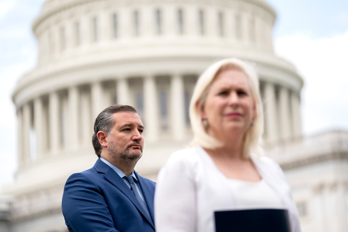 Senator Ted Cruz and Senator Kirsten Gillibrand listen during a news conference outside the Capitol.