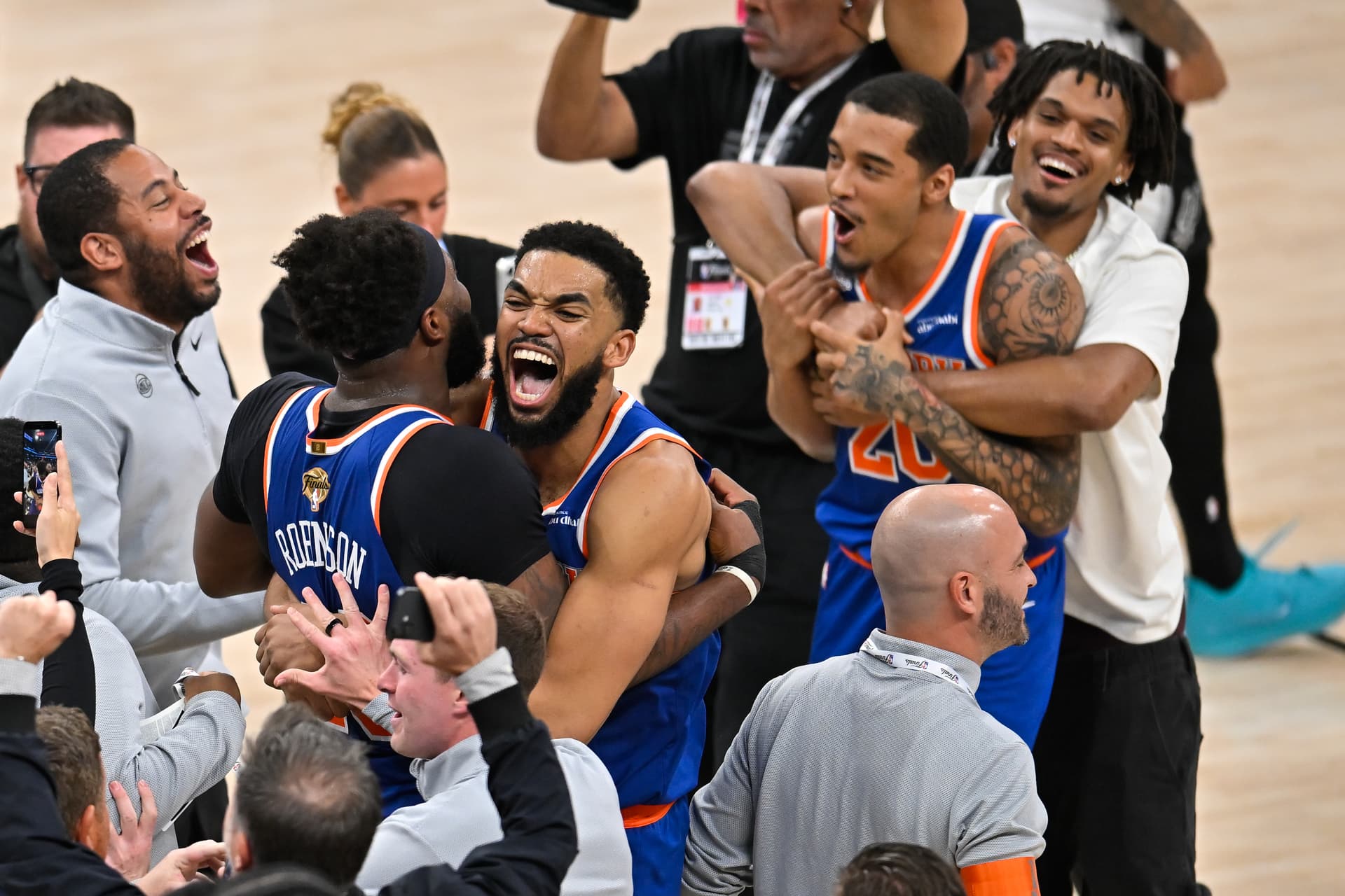 The New York Knicks' center Karl-Anthony Towns, right, hugs center Mitchell Robinson after defeating the San Antonio Spurs in Game 5 of the NBA Finals basketball series, June 13, 2026, at San Antonio. 
