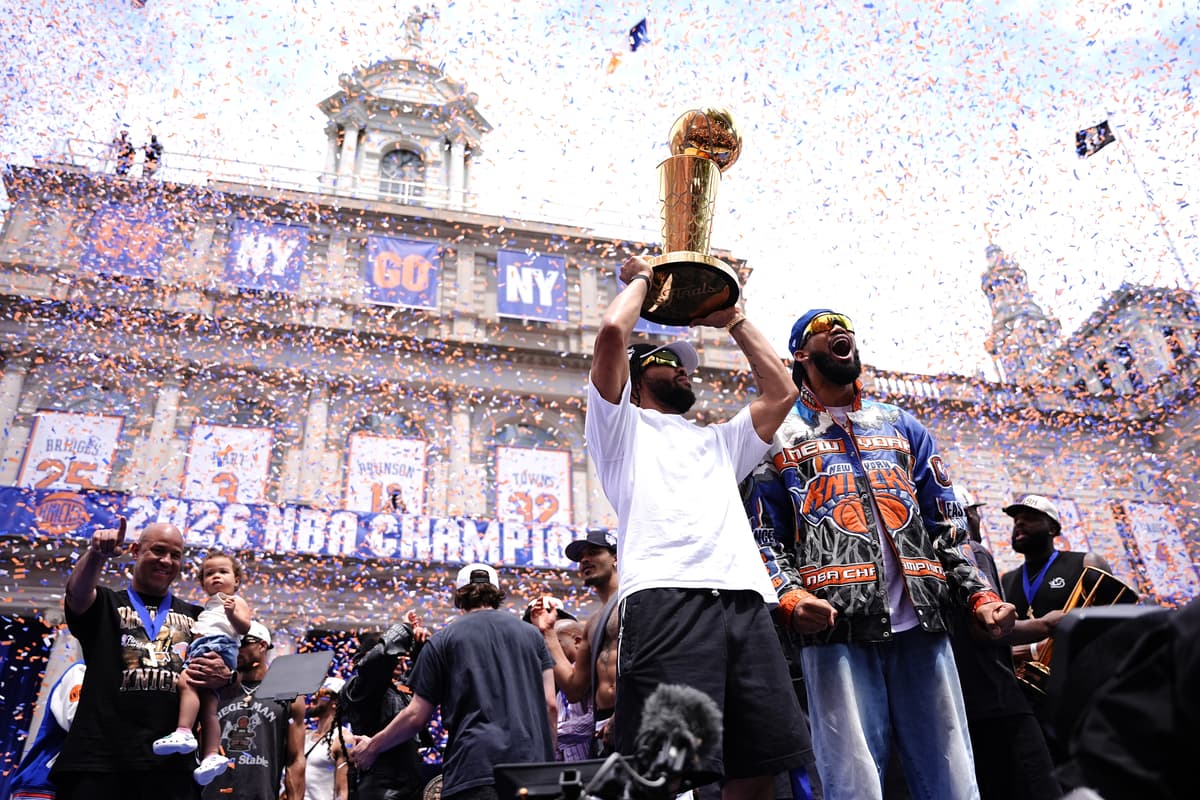 Jalen Brunson #11 and Karl-Anthony Towns #32 of the New York Knicks celebrate with the Larry O'Brien Championship Trophy during the New York Knicks Championship ticker tape parade.
