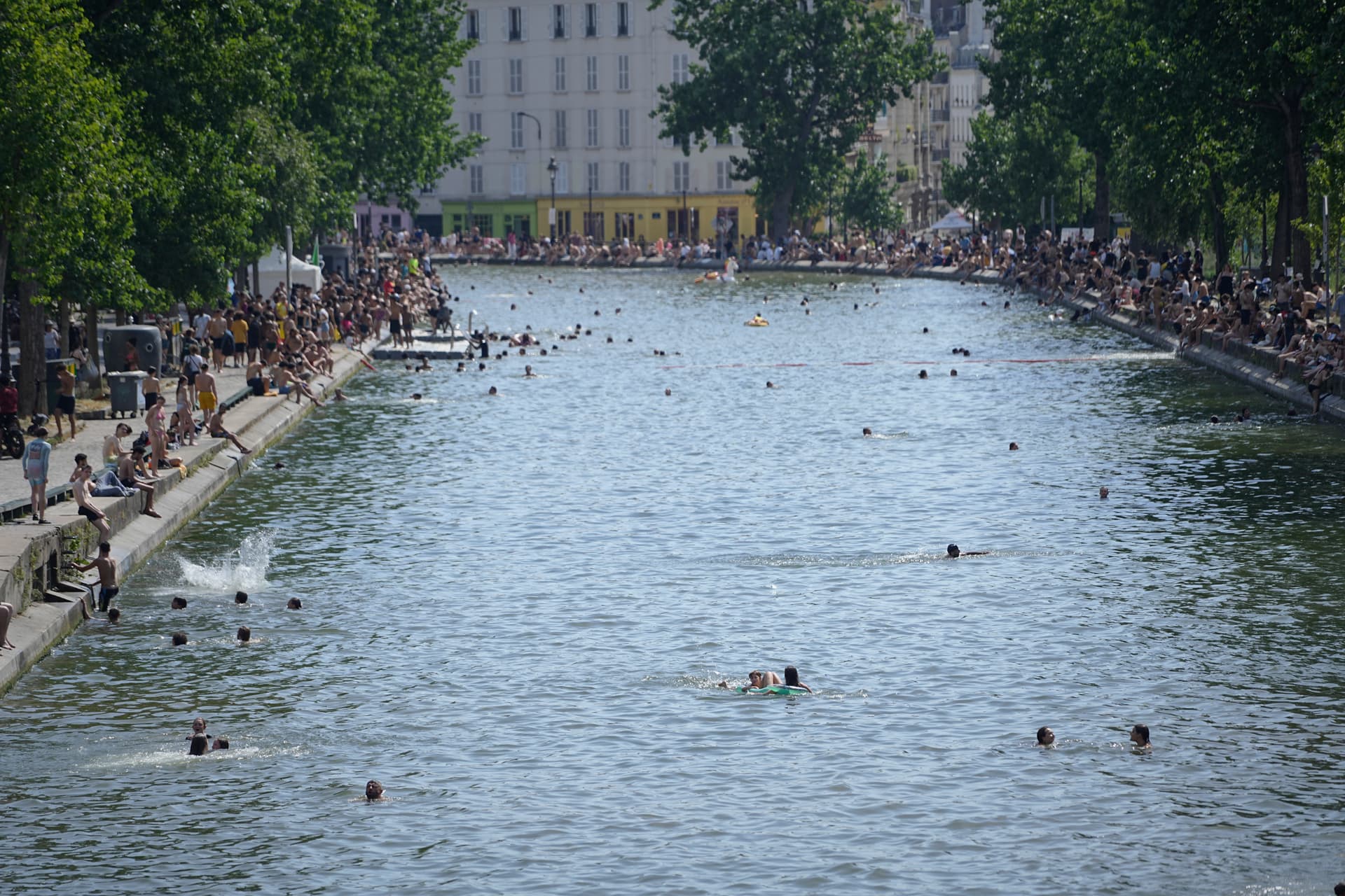 People are seen swimming in the Canal Saint Martin during a heat wave that has temperatures soaring to well over 40 degrees fahrenheit on June 23, 2026 at Paris, France. 