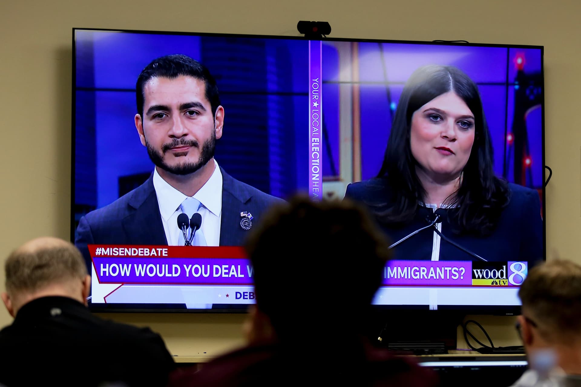 Michigan U.S. Senate candidates, Abdul El-Sayed, left, and Congresswoman Haley Stevens, are displayed on a television during a debate inside the spin room at WoodTV studios on July 7, 2026, at Grand Rapids, Michigan.