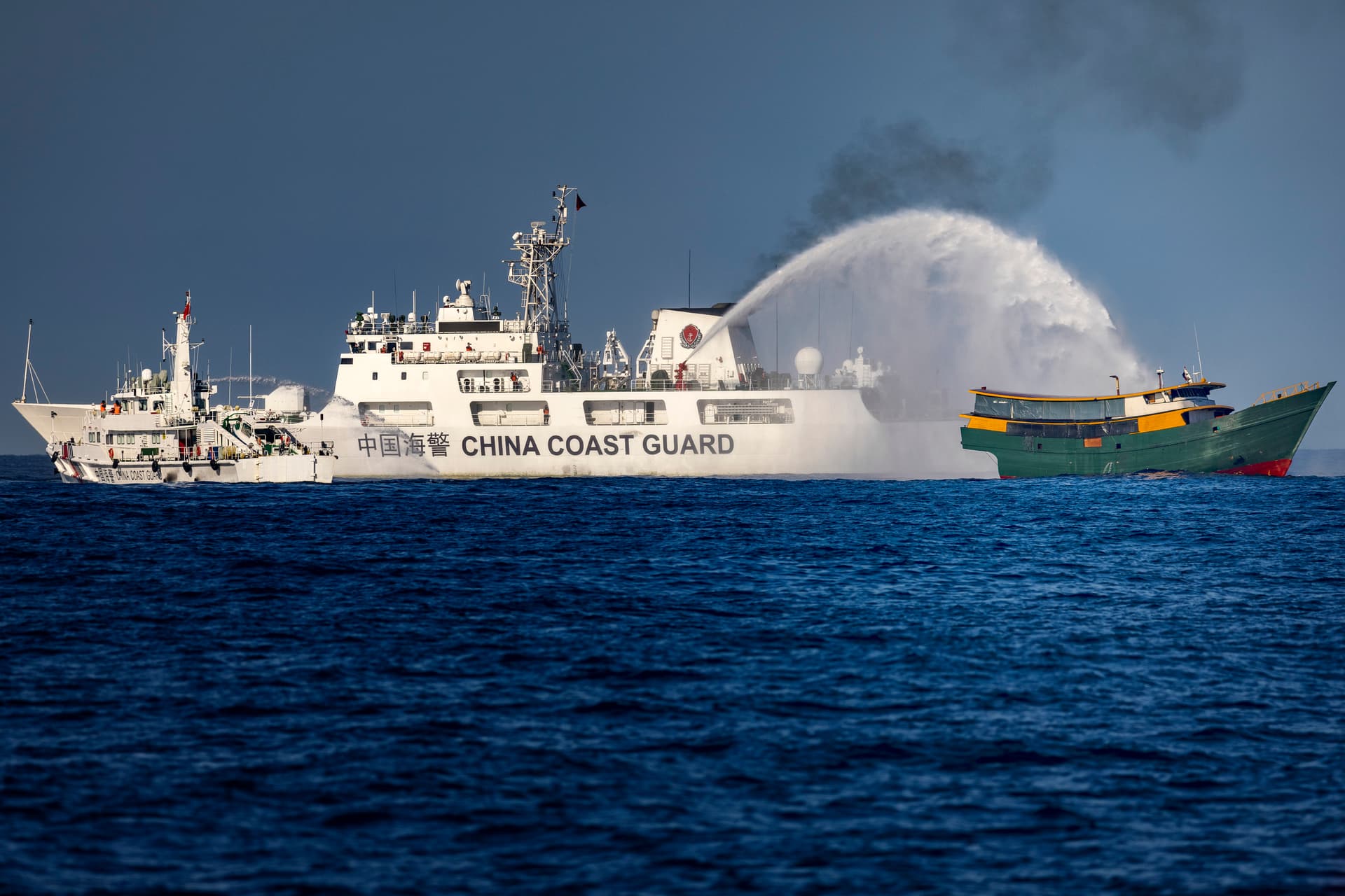 A Chinese Coast Guard ship fires a water cannon at a Philippine Navy chartered vessel on a resupply mission to troops stationed at Second Thomas Shoal in the South China Sea on March 5, 2024.