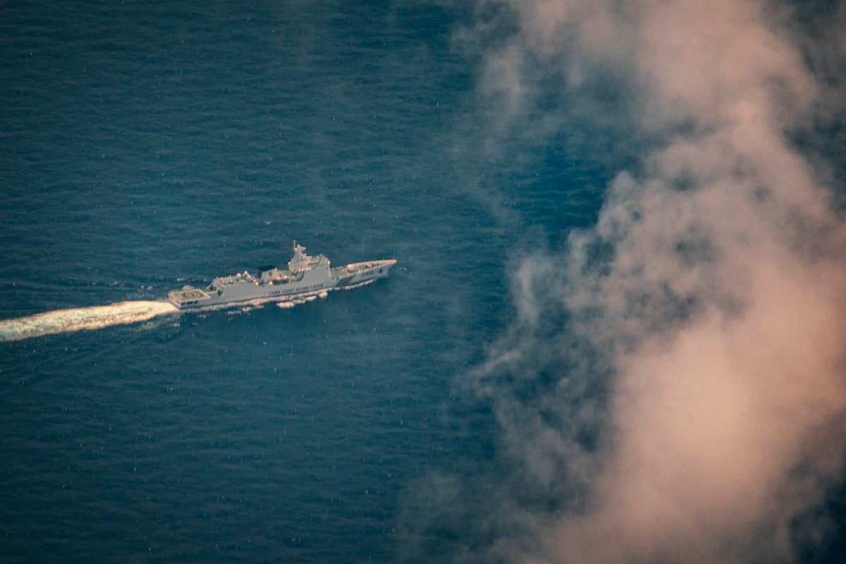 A Chinese Coast Guard ship is seen from aboard a Philippine Bureau of Fisheries and Aquatic Resources (BFAR) plane on June 15, 2026, in Scarborough Shoal, South China Sea. Chinese research vessels were recently spotted near Scarborough Shoal as the Philippines protested a suspected Chinese floating platform there, raising fresh concerns that Beijing could be testing steps toward a more permanent presence at the disputed South China Sea flashpoint.  