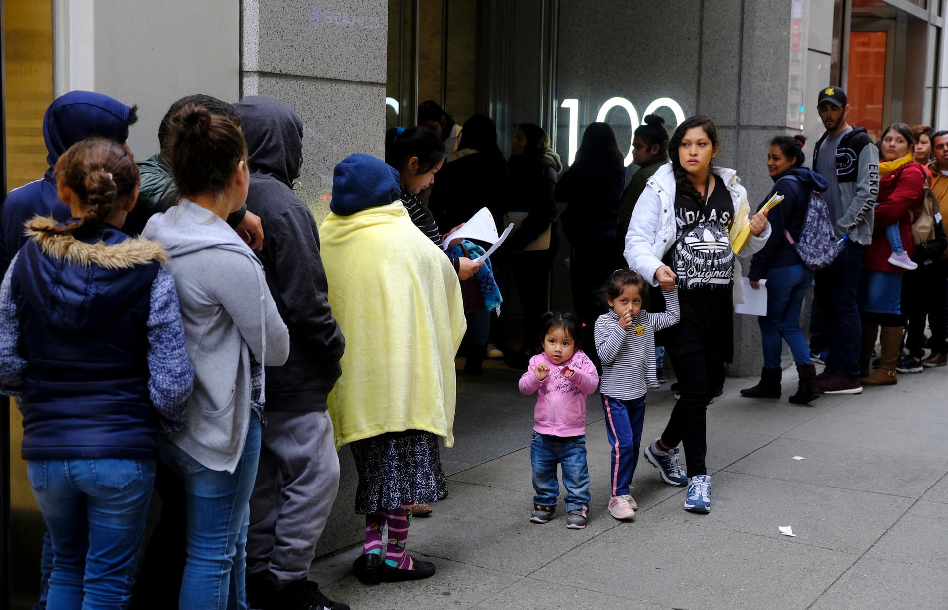 Prospective immigrants stand in line outside a United States immigration office with numerous courtrooms at San Francisco on January 31, 2019.