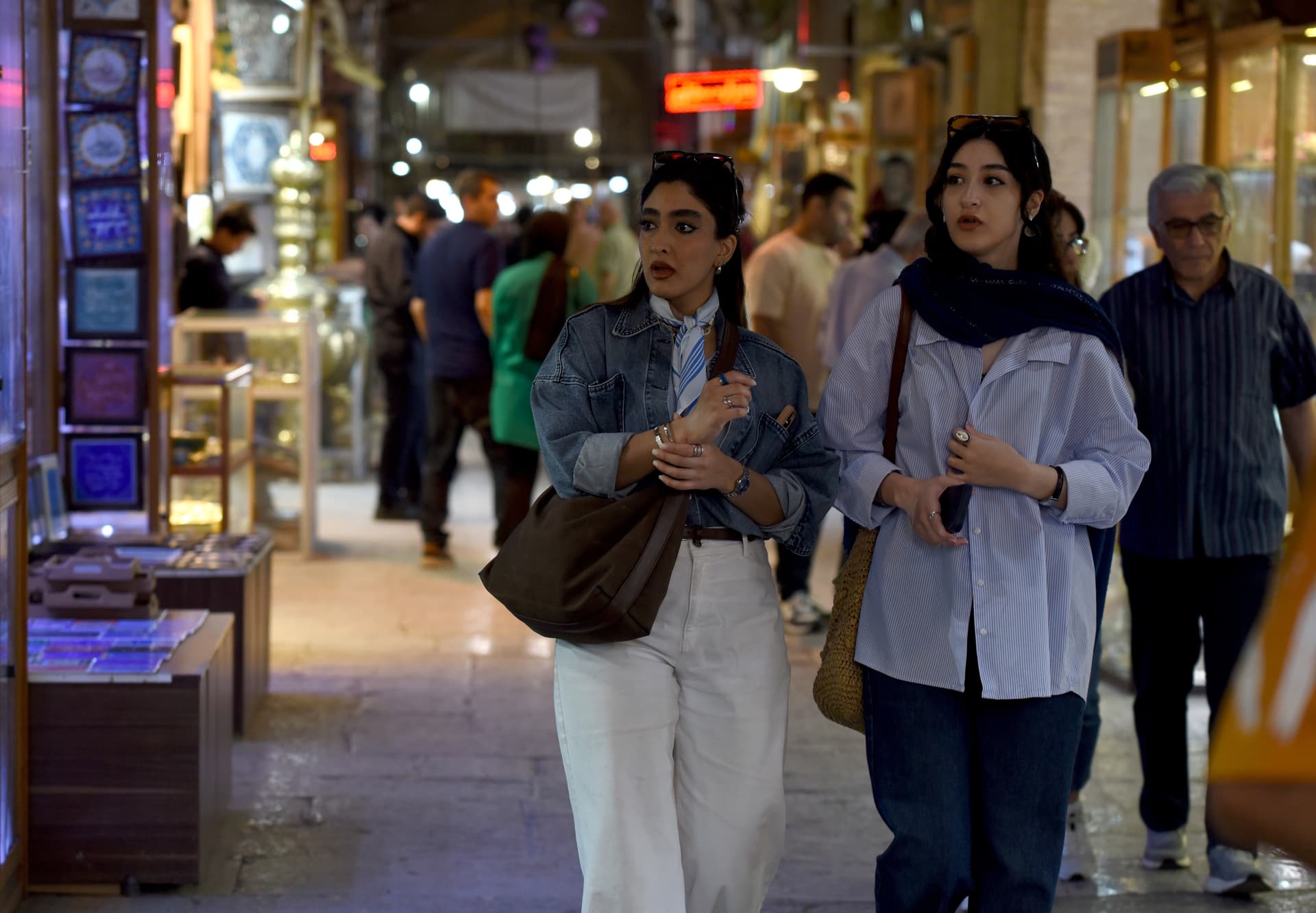 Young women walk without head coverings in the main bazaar at Isfahan, Iran, on April 30, 2026.