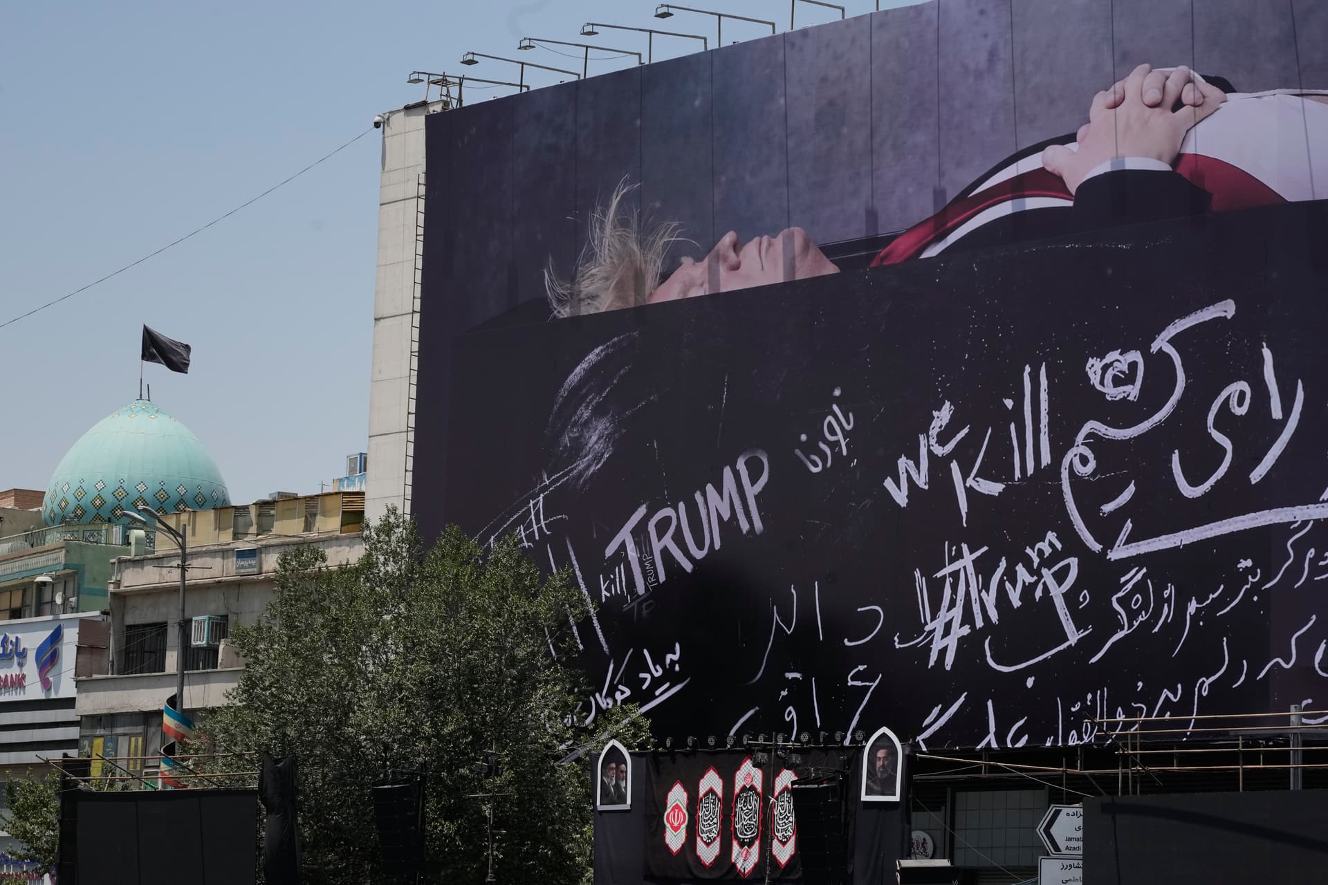 A billboard depicting President Trump lying on what appears to be a coffin and bearing anti-Trump messages  is seen at Islamic Revolution Square at Tehran, Iran, on July 15, 2026.