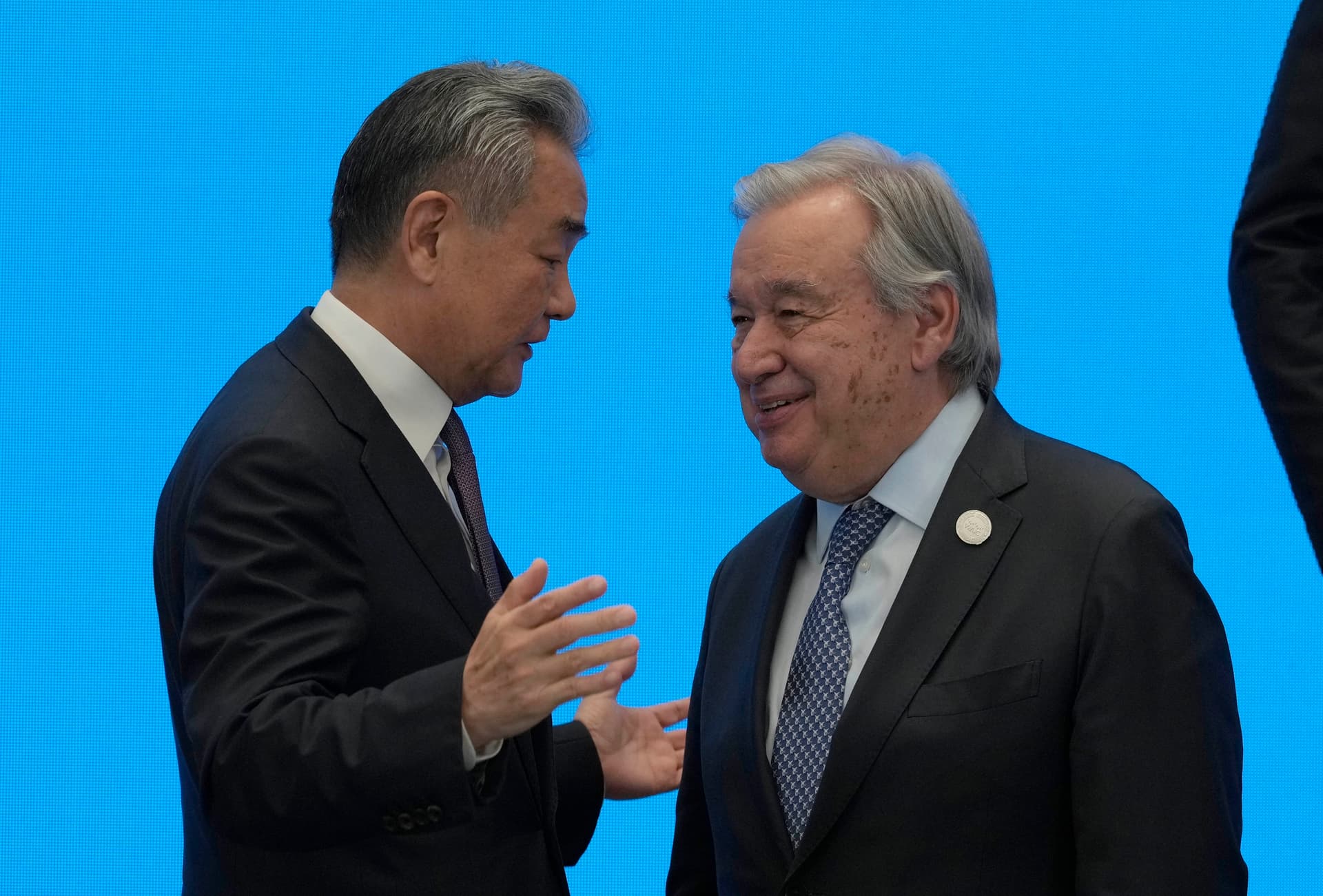 China’s foreign minister, Wang Yi, shakes hands with UN Secretary-General António Guterres on July 16, 2026, ahead of the World AI Conference at Shanghai.
