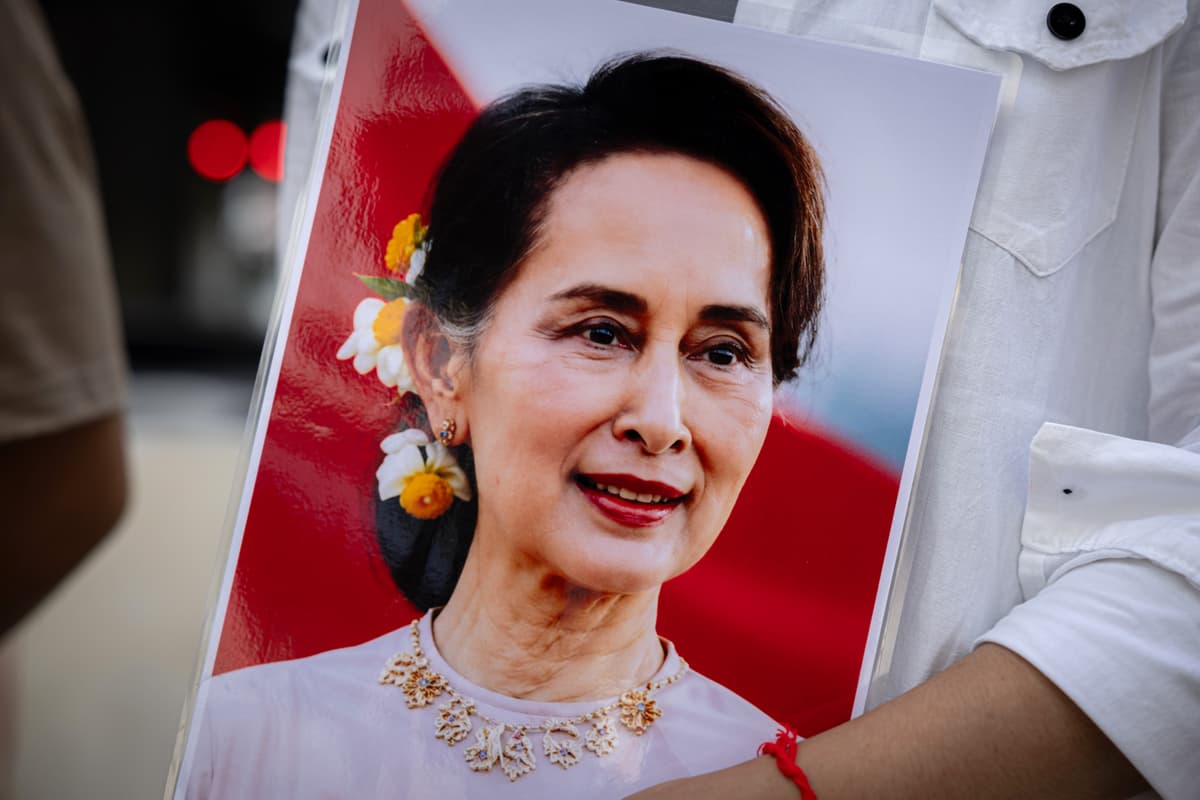 Myanmar migrant group members hold a framed photo of Aung San Suu Kyi, who was recently moved from prison to house arrest, during a Labor Day rally at the Bangkok Art and Culture Center on May 1, 2026 at Bangkok, Thailand. 