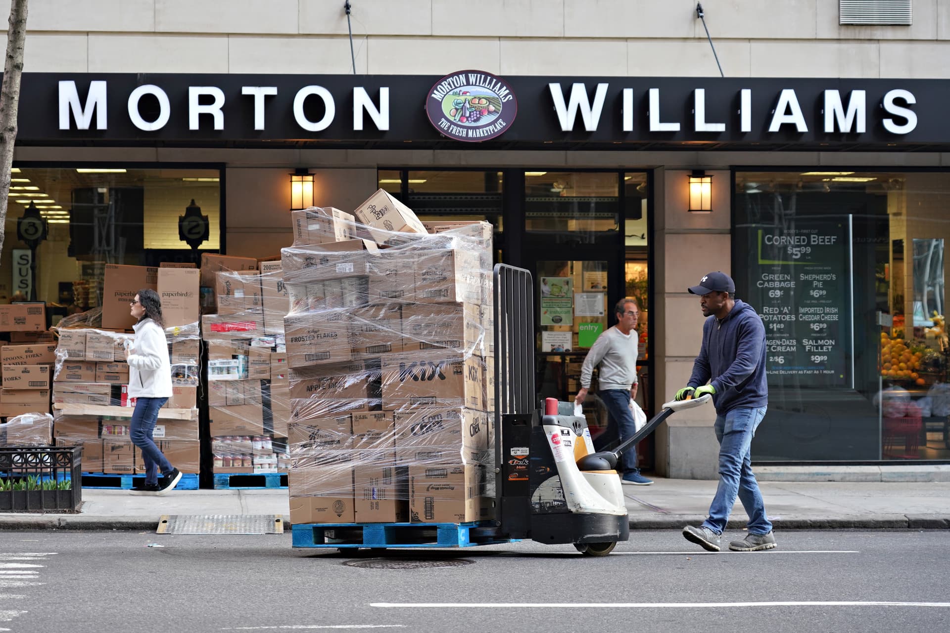 A deliveryman moves supplies into a Morton Williams grocery store at New York City on March 20, 2020.
