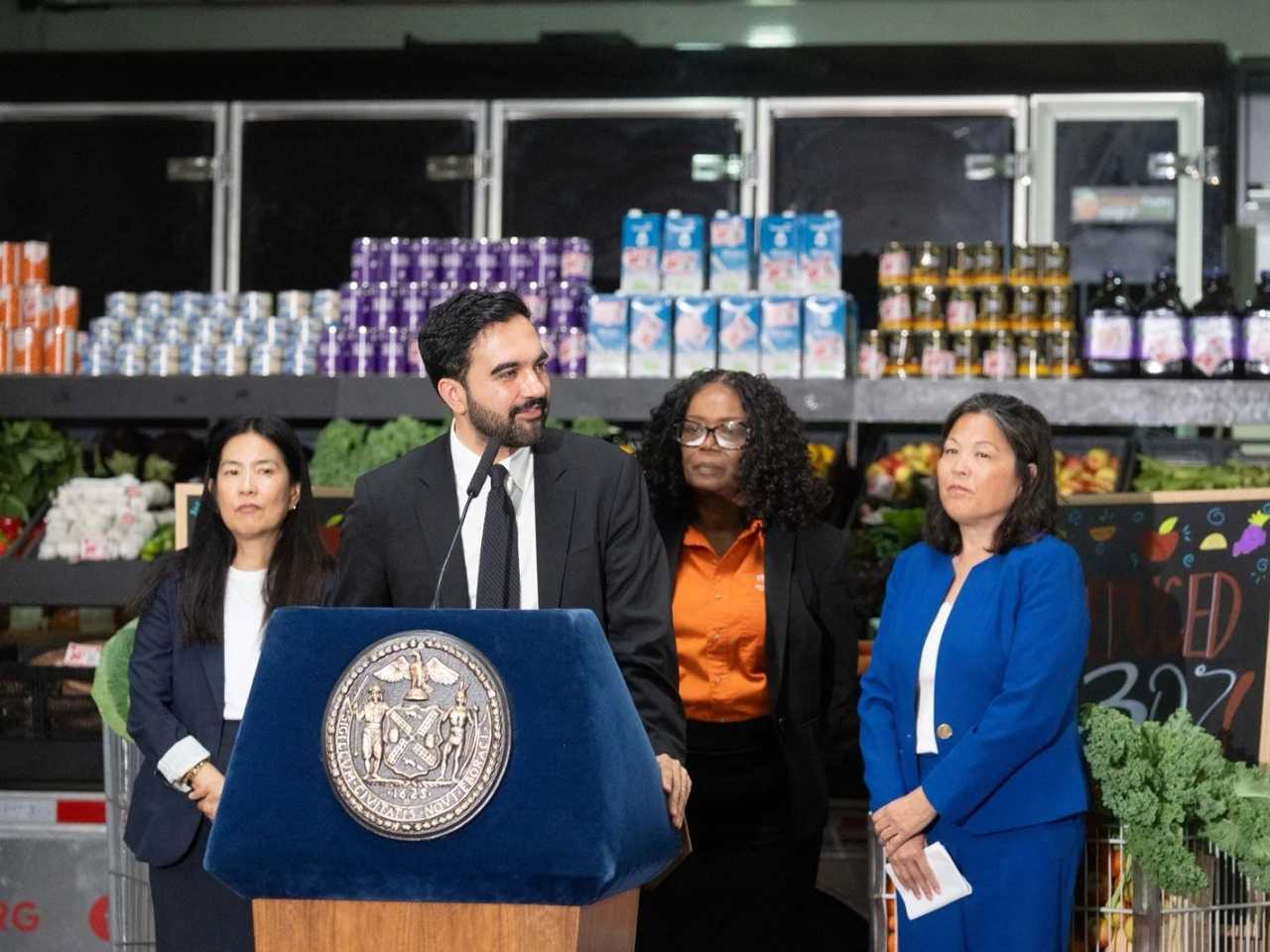 In a press conference on July 27, 2026, Mayor Zohran Mamdani of New York City announces that city-run grocery stores will offer a 30-percent  discount on produce, meat, and kitchen staples.
