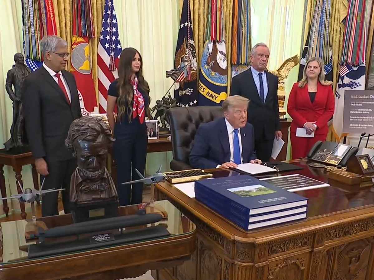 President Trump, joined by NIH Director Jay Battacharya and Health and Human Services Secretary Robert F. Kennedy Jr., signs an executive order changing the childhood vaccine schedule at an Oval Office announcement at the White House on August 10, 2026.