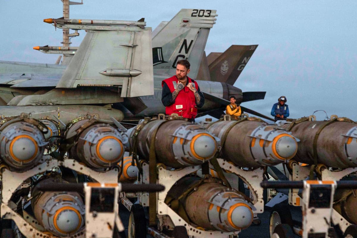 American sailors transfer ordnance on the flight deck of Nimitz-class aircraft carrier United States Ship Abraham Lincoln on February 27, 2026 in the Arabian Sea. 