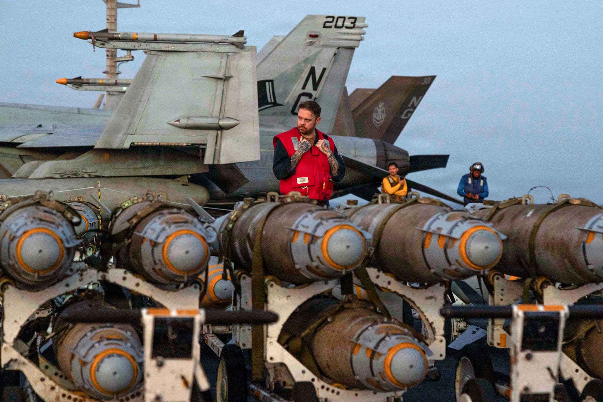 American sailors transfer ordnance on the flight deck of Nimitz-class aircraft carrier United States Ship Abraham Lincoln on February 27, 2026 in the Arabian Sea. 