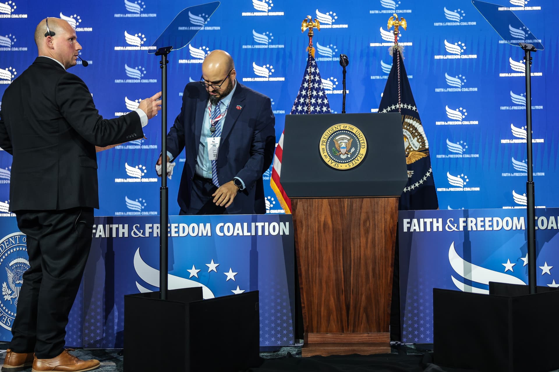  White House staffers, including Gabriel Perez (right) set up a teleprompter before President Trump speaks at the Faith & Freedom Coalition's 2026 Policy Conference at Washington, D.C., on June 26, 2026.