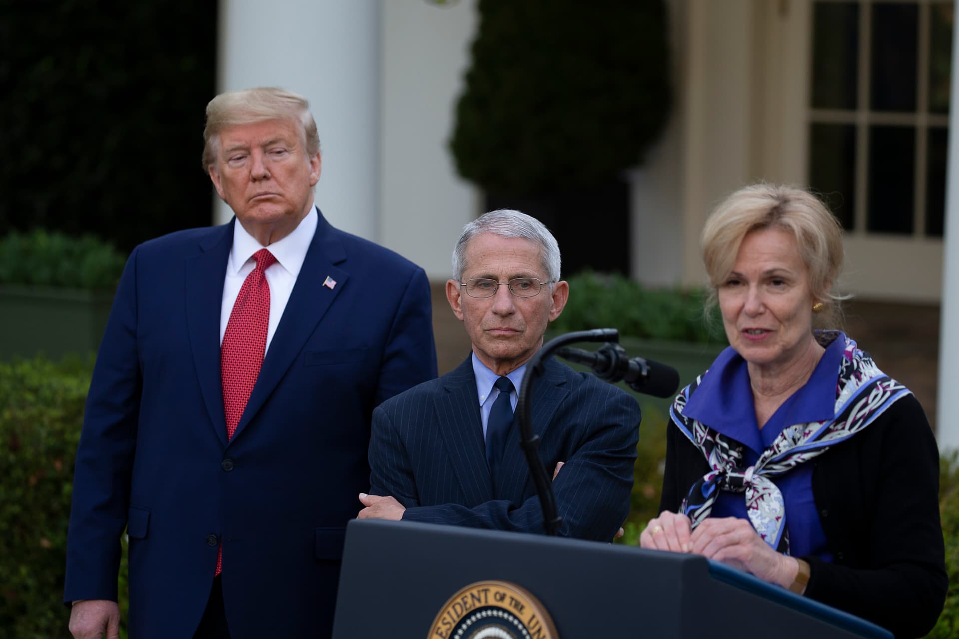 President Trump and medical adviser Anthony Fauci listen to the White House coronavirus response coordinator, Deborah Birx, at the Rose Garden on March 29, 2020.
