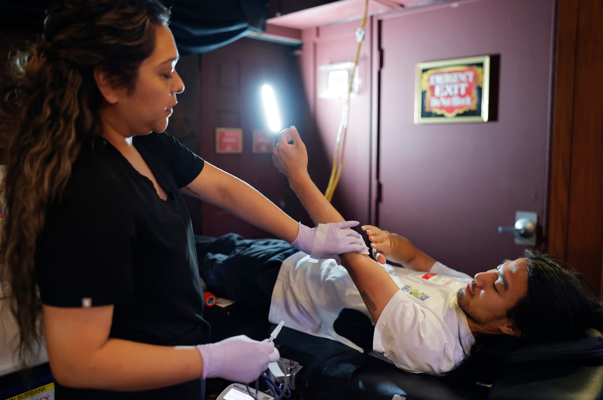A clinician assists a blood donor during an American Red Cross blood drive at Hollywood's Magic Castle at Los Angeles, California, on July 28, 2026.