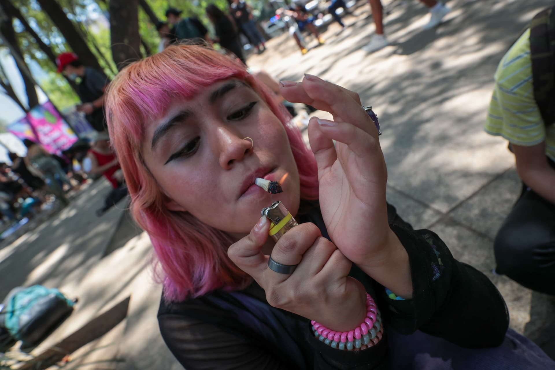 A woman smokes cannabis during 4/20 cannabis day celebrations. 