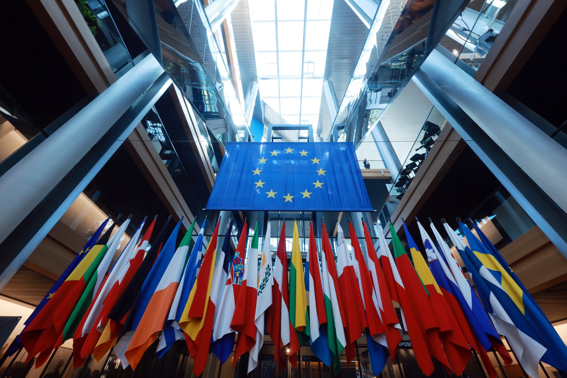 Flags of member states of the European Union stand in an atrium of the European Parliament building in Strasbourg, France. 